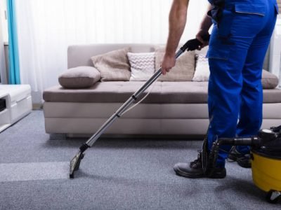 Janitor's Hand Cleaning Carpet With Vacuum Cleaner